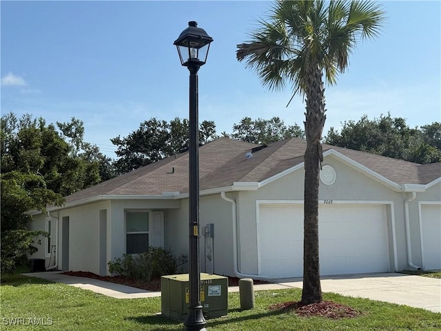 9069 Aegean Cir, Lehigh Acres, FL 33936 - ranch-style house with stucco siding, an attached garage, concrete driveway, a front yard, and a shingled roof