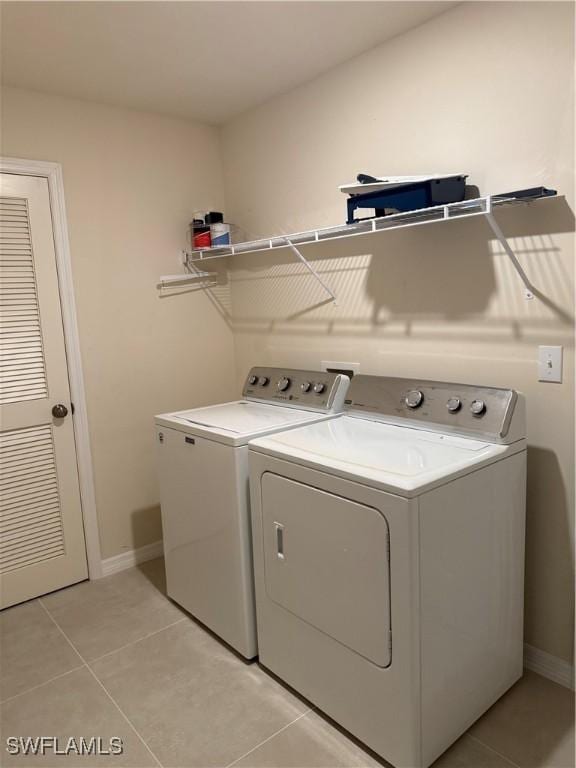 9069 Aegean Cir, Lehigh Acres, FL 33936 - washroom featuring separate washer and dryer and light tile patterned floors