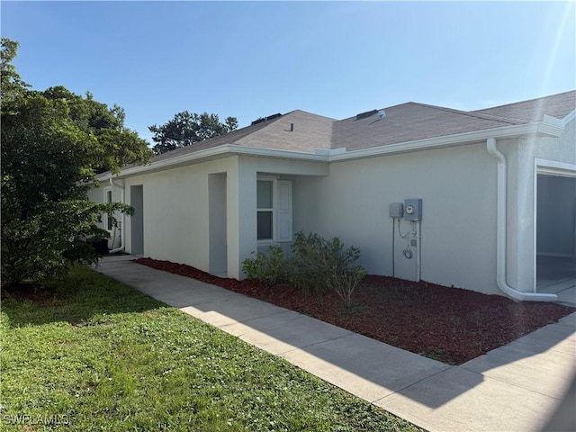 9069 Aegean Cir, Lehigh Acres, FL 33936 - view of home's exterior featuring stucco siding