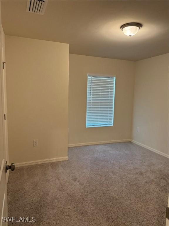 9069 Aegean Cir, Lehigh Acres, FL 33936 - empty room featuring carpet floors and baseboards