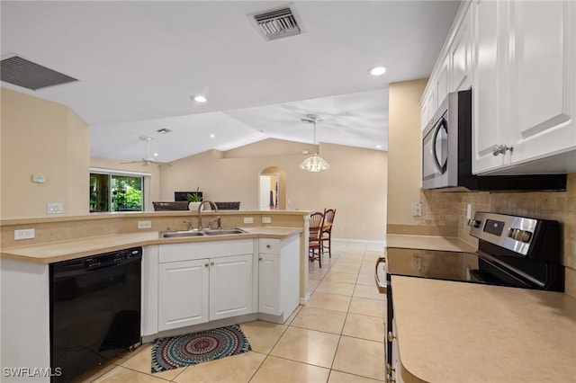 873 Spaulding St E, Lehigh Acres, FL 33974 - kitchen featuring stainless steel appliances, light tile patterned floors, lofted ceiling, decorative backsplash, and light countertops