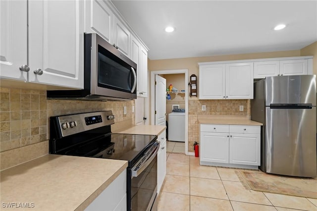 873 Spaulding St E, Lehigh Acres, FL 33974 - kitchen with appliances with stainless steel finishes, washer / clothes dryer, decorative backsplash, light countertops, and recessed lighting