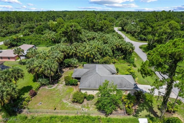 873 Spaulding St E, Lehigh Acres, FL 33974 - aerial view of property and surrounding area featuring a heavily wooded area