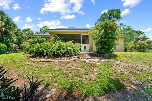 873 Spaulding St E, Lehigh Acres, FL 33974 - view of front facade featuring stucco siding, a sunroom, and a ceiling fan