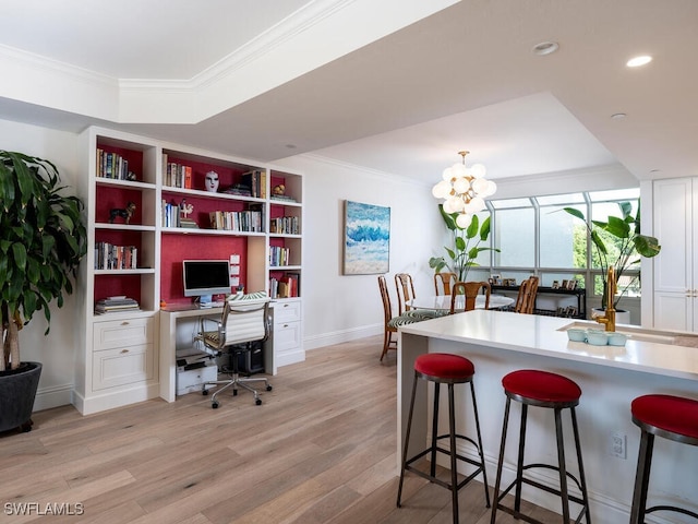 8440 Abbington Cir Unit D22, Naples, FL 34108 - kitchen with crown molding, a desk, light wood finished floors, a breakfast bar area, and white cabinets