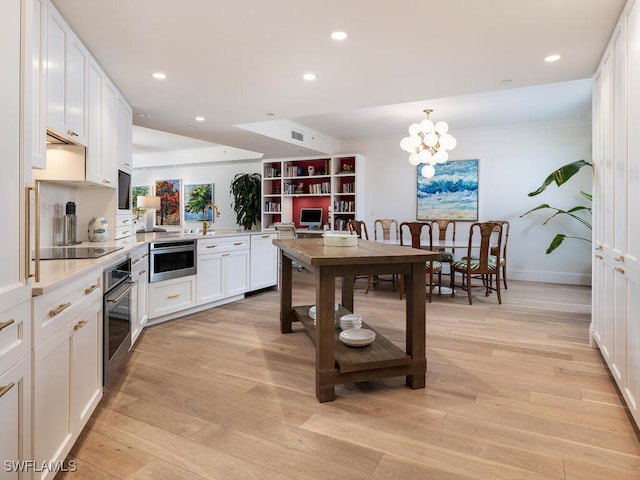 8440 Abbington Cir Unit D22, Naples, FL 34108 - kitchen featuring dishwasher, black electric stovetop, light countertops, stainless steel oven, and white cabinetry