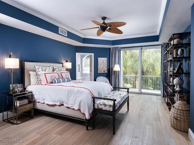 8440 Abbington Cir Unit D22, Naples, FL 34108 - bedroom featuring access to exterior, wood finished floors, a raised ceiling, ornamental molding, and ceiling fan