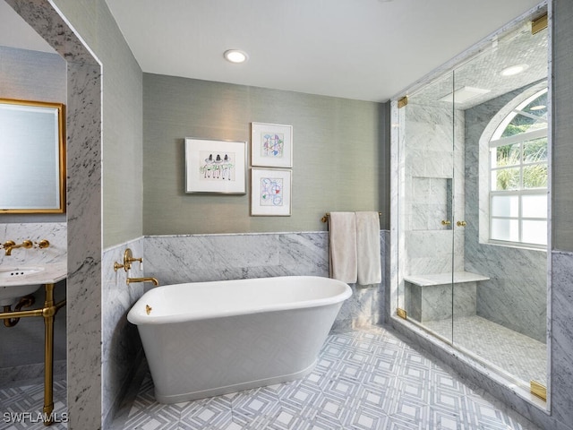8440 Abbington Cir Unit D22, Naples, FL 34108 - bathroom featuring tile walls, a freestanding bath, a shower stall, wainscoting, and tile patterned floors