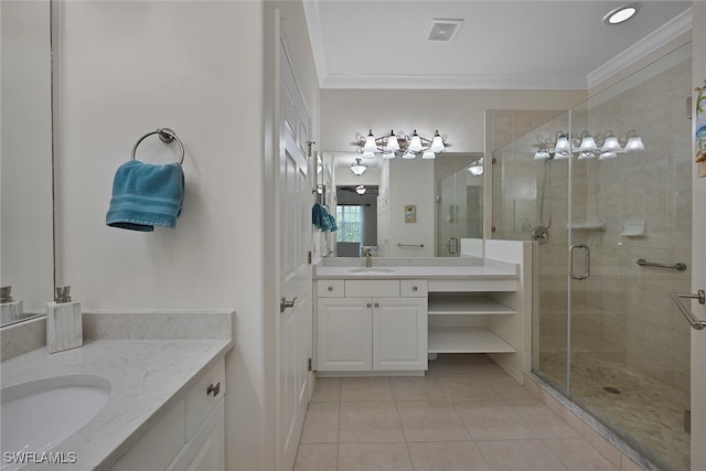 4844 Hampshire Ct Unit 305, Naples, FL 34112 - bathroom with tile patterned floors, two vanities, a stall shower, and ornamental molding