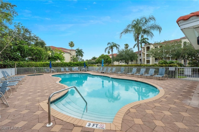 4844 Hampshire Ct Unit 305, Naples, FL 34112 - community pool featuring a patio area