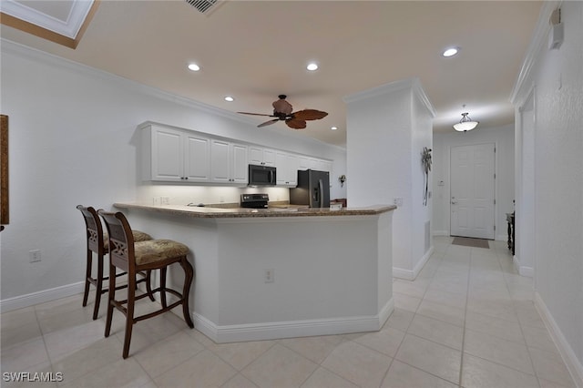 4844 Hampshire Ct Unit 305, Naples, FL 34112 - kitchen with appliances with stainless steel finishes, ornamental molding, recessed lighting, a ceiling fan, and a peninsula