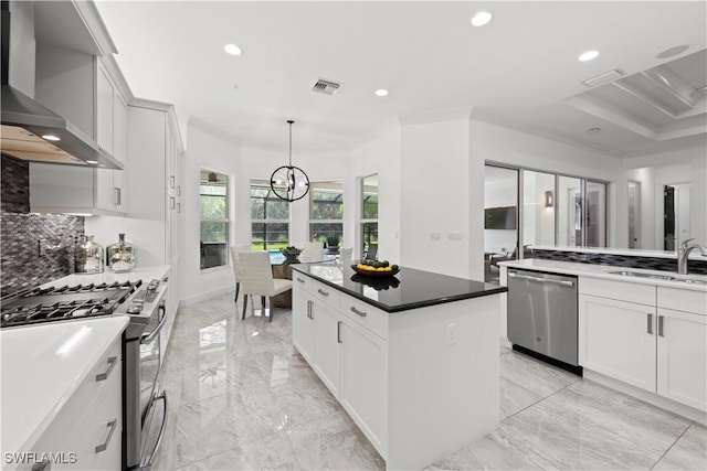 28617 Sicily Loop, Bonita Springs, FL 34135 - kitchen with appliances with stainless steel finishes, wall chimney range hood, recessed lighting, a center island, and light marble finish floors