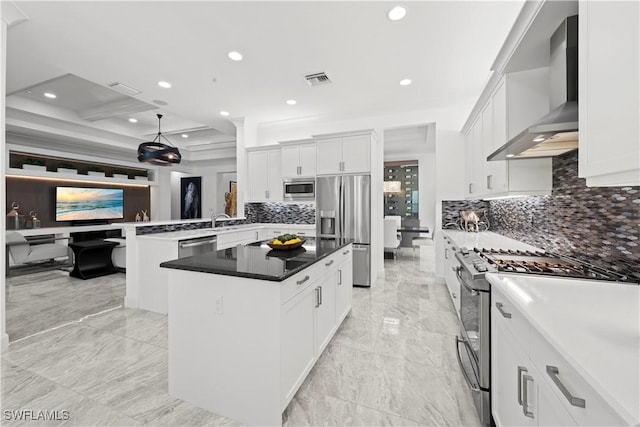 28617 Sicily Loop, Bonita Springs, FL 34135 - kitchen with appliances with stainless steel finishes, wall chimney exhaust hood, a peninsula, recessed lighting, and decorative backsplash