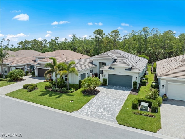 28617 Sicily Loop, Bonita Springs, FL 34135 - view of front of house with a tile roof, a front yard, stucco siding, and decorative driveway