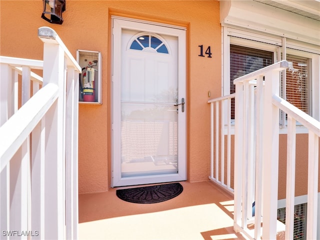 6790 Beach Resort Dr Unit 14, Naples, FL 34114 - doorway to property with stucco siding