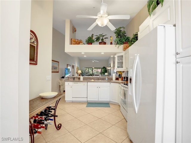 6790 Beach Resort Dr Unit 14, Naples, FL 34114 - kitchen featuring white appliances, a ceiling fan, a peninsula, a towering ceiling, and white cabinets