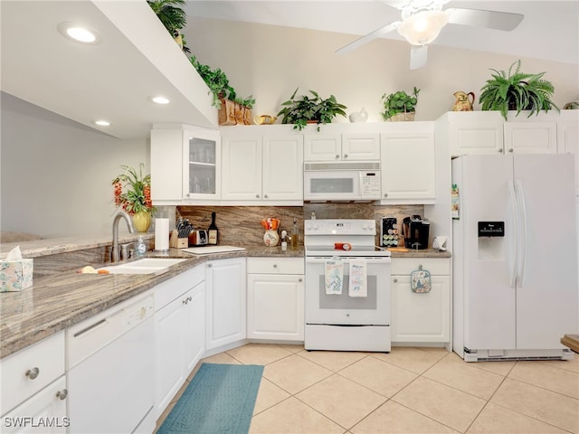 6790 Beach Resort Dr Unit 14, Naples, FL 34114 - kitchen with white appliances, backsplash, light tile patterned floors, white cabinetry, and glass insert cabinets
