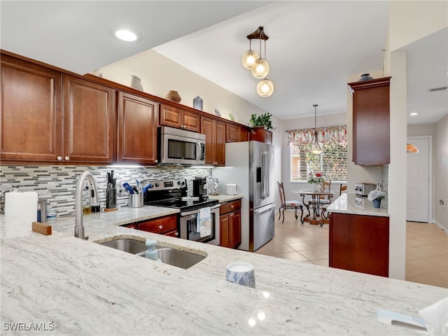 6790 Beach Resort Dr Unit 13, Naples, FL 34114 - kitchen with stainless steel appliances, light stone counters, tasteful backsplash, and light tile patterned floors