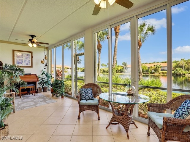 6790 Beach Resort Dr Unit 13, Naples, FL 34114 - sunroom with a water view, floor to ceiling windows, tile patterned floors, and a textured ceiling
