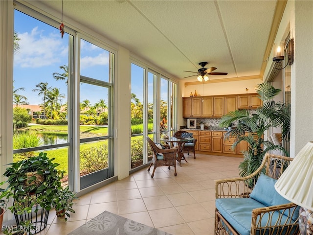 6790 Beach Resort Dr Unit 13, Naples, FL 34114 - sunroom / solarium with tile patterned floors, a textured ceiling, and a water view