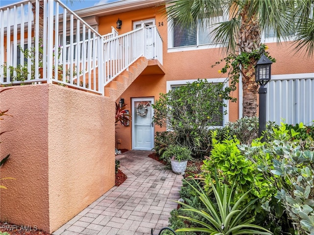 6790 Beach Resort Dr Unit 13, Naples, FL 34114 - entrance to property featuring stucco siding and a balcony