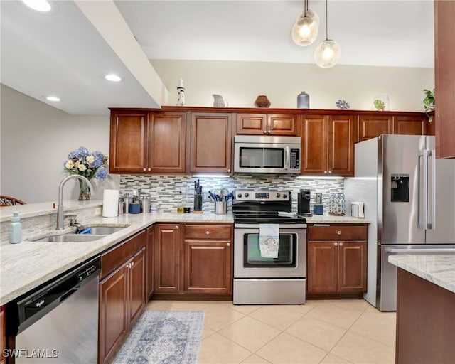 6790 Beach Resort Dr Unit 13, Naples, FL 34114 - kitchen with stainless steel appliances, decorative backsplash, light tile patterned flooring, light stone counters, and decorative light fixtures
