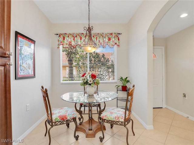 6790 Beach Resort Dr Unit 13, Naples, FL 34114 - dining room featuring arched walkways and light tile patterned floors