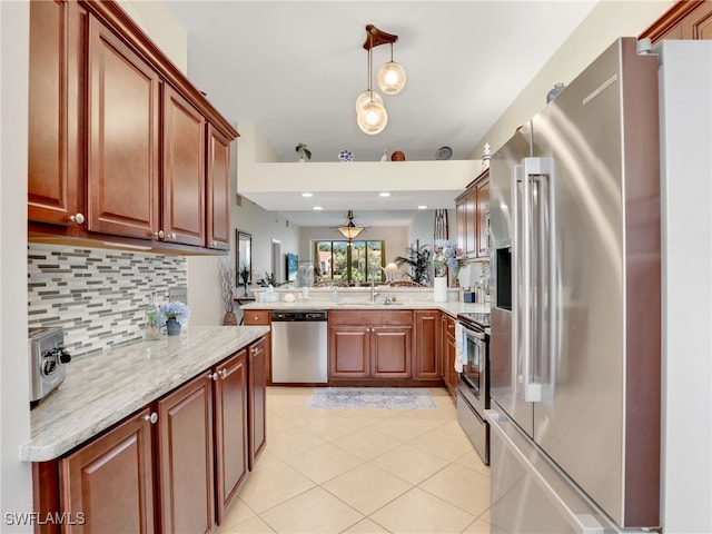 6790 Beach Resort Dr Unit 13, Naples, FL 34114 - kitchen with appliances with stainless steel finishes, a peninsula, decorative backsplash, light tile patterned floors, and hanging light fixtures