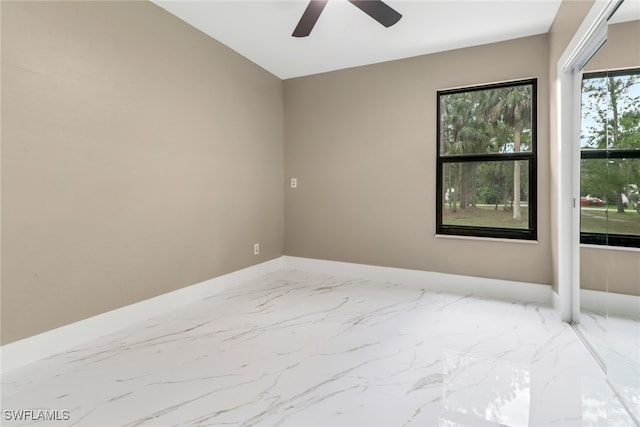 431 1st St NW, Naples, FL 34120 - unfurnished room featuring ceiling fan and marble finish floors