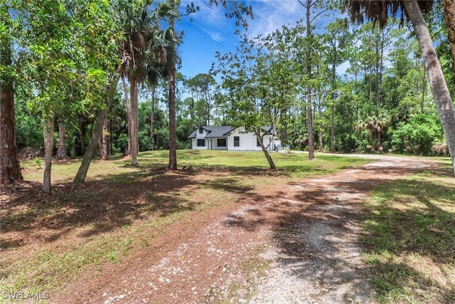 431 1st St NW, Naples, FL 34120 - view of front of home featuring driveway and a front yard