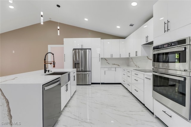 431 1st St NW, Naples, FL 34120 - kitchen featuring stainless steel appliances, modern cabinets, lofted ceiling, light marble finish flooring, and recessed lighting