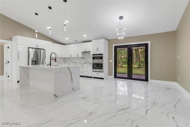 431 1st St NW, Naples, FL 34120 - kitchen featuring stainless steel appliances, light marble finish flooring, white cabinetry, french doors, and lofted ceiling