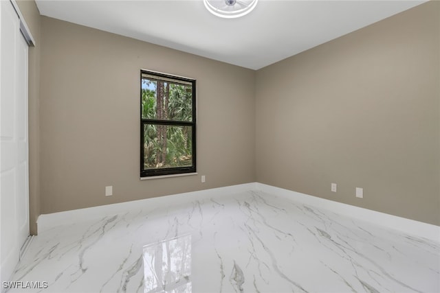 431 1st St NW, Naples, FL 34120 - empty room with marble finish flooring and baseboards
