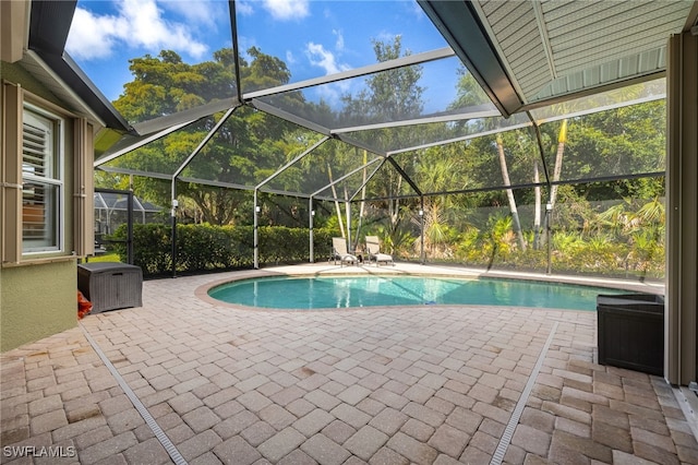 12977 Turtle Cove Trl, North Fort Myers, FL 33903 - swimming pool featuring a patio area and glass enclosure