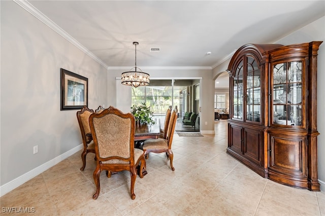 12977 Turtle Cove Trl, North Fort Myers, FL 33903 - dining area featuring a chandelier, crown molding, light tile patterned floors, and arched walkways