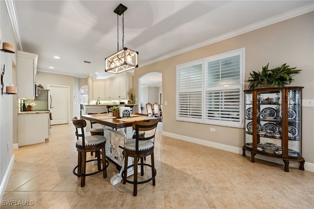 12977 Turtle Cove Trl, North Fort Myers, FL 33903 - dining area featuring arched walkways, crown molding, recessed lighting, light tile patterned floors, and a chandelier