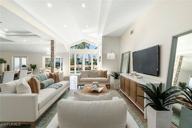5203 Starfish Ave, Naples, FL 34103 - living room with wood finished floors, plenty of natural light, recessed lighting, french doors, and vaulted ceiling