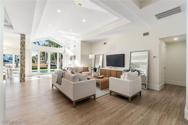 5203 Starfish Ave, Naples, FL 34103 - living room featuring light wood finished floors, a towering ceiling, and recessed lighting