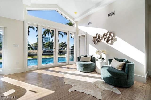 5203 Starfish Ave, Naples, FL 34103 - sitting room featuring high vaulted ceiling and wood finished floors