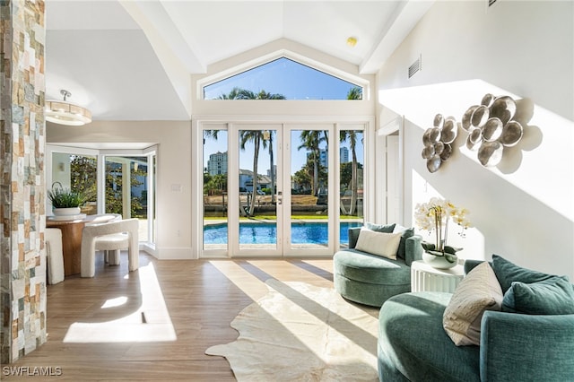 5203 Starfish Ave, Naples, FL 34103 - sitting room with wood finished floors, french doors, and high vaulted ceiling