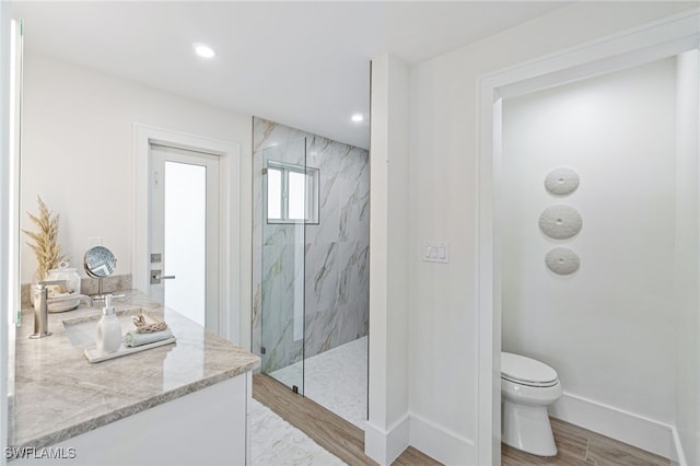 5203 Starfish Ave, Naples, FL 34103 - bathroom featuring a marble finish shower, vanity, recessed lighting, and wood finished floors
