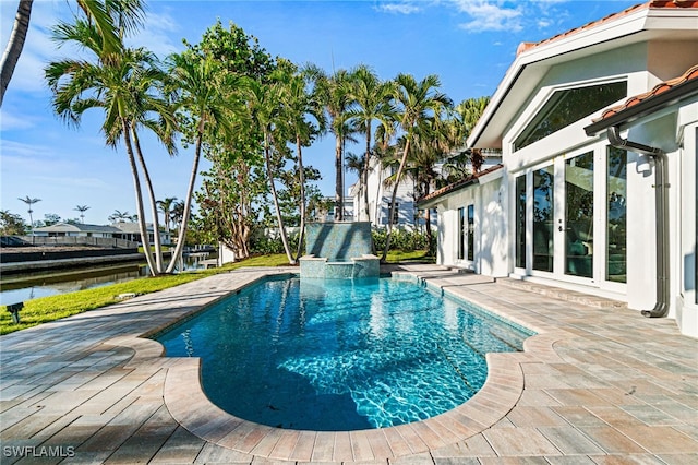 5203 Starfish Ave, Naples, FL 34103 - view of swimming pool featuring a patio area, a pool with connected hot tub, and a water view