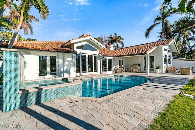 5203 Starfish Ave, Naples, FL 34103 - back of property with french doors, a tiled roof, stucco siding, and a patio