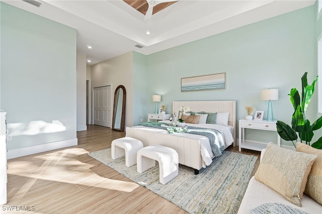 5203 Starfish Ave, Naples, FL 34103 - bedroom with recessed lighting, wood finished floors, and a tray ceiling