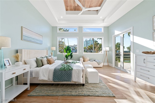 5203 Starfish Ave, Naples, FL 34103 - bedroom featuring access to outside, wood finished floors, a tray ceiling, and recessed lighting