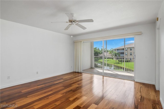 9650 Victoria Ln Unit 201B, Naples, FL 34109 - spare room with wood finished floors and ceiling fan
