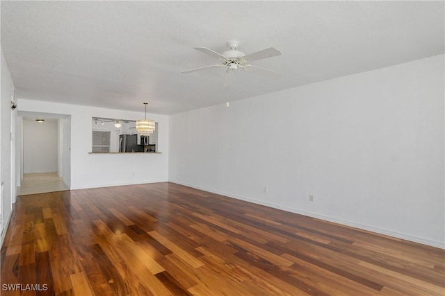 9650 Victoria Ln Unit 201B, Naples, FL 34109 - unfurnished living room featuring wood finished floors, a chandelier, and ceiling fan