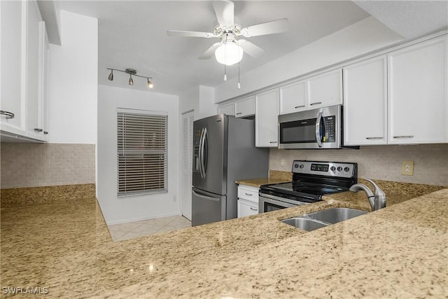 9650 Victoria Ln Unit 201B, Naples, FL 34109 - kitchen with stainless steel appliances, a ceiling fan, white cabinetry, and light stone counters