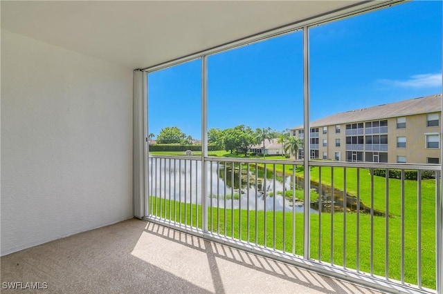 9650 Victoria Ln Unit 201B, Naples, FL 34109 - unfurnished sunroom with a water view