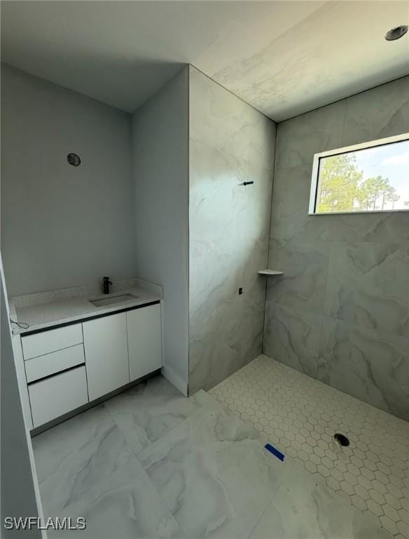 3722 29th Ave NE, Naples, FL 34120 - bathroom with vanity, marble look tiles, and a shower